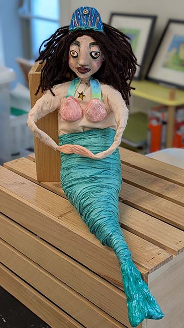 Merry Mermaid lives in the sea.